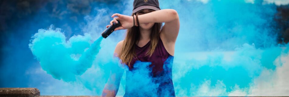 woman holding blue smoke flare